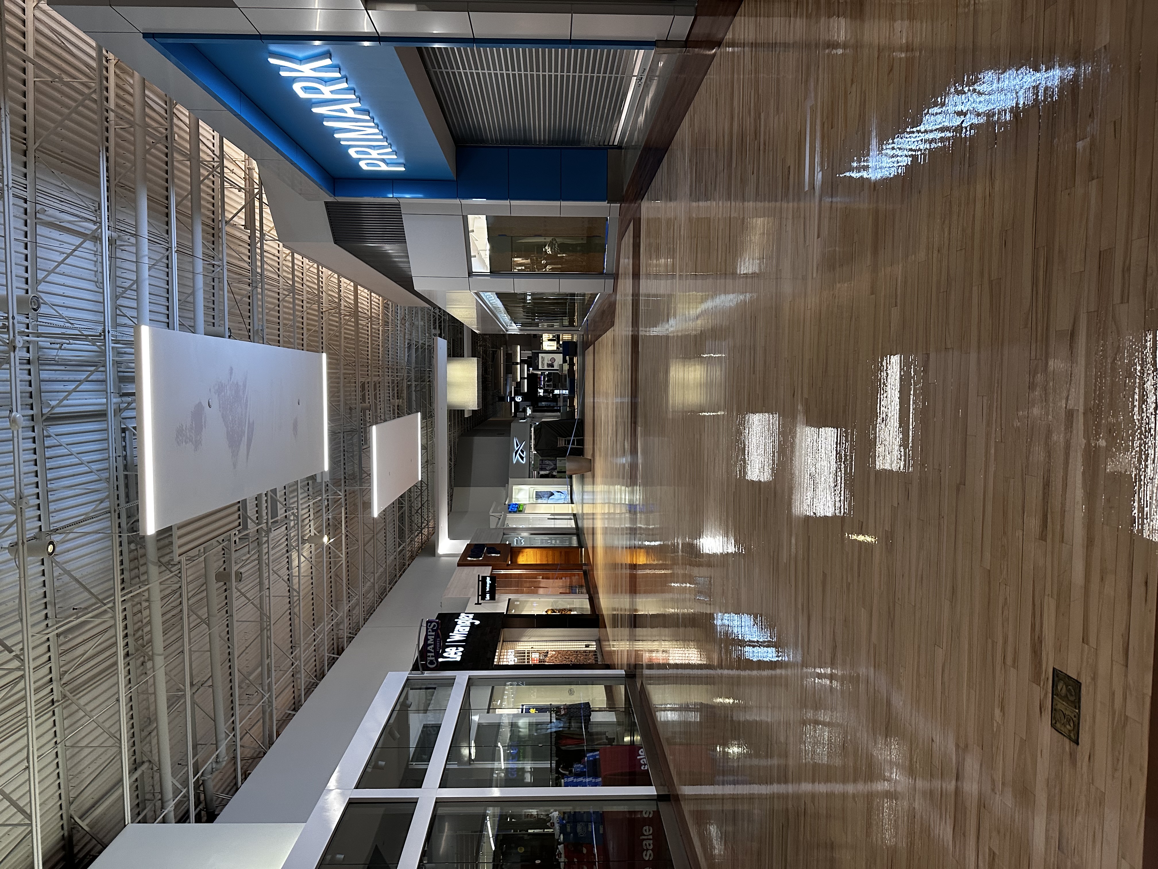 Glossy commercial wood floor running down a mall corridor