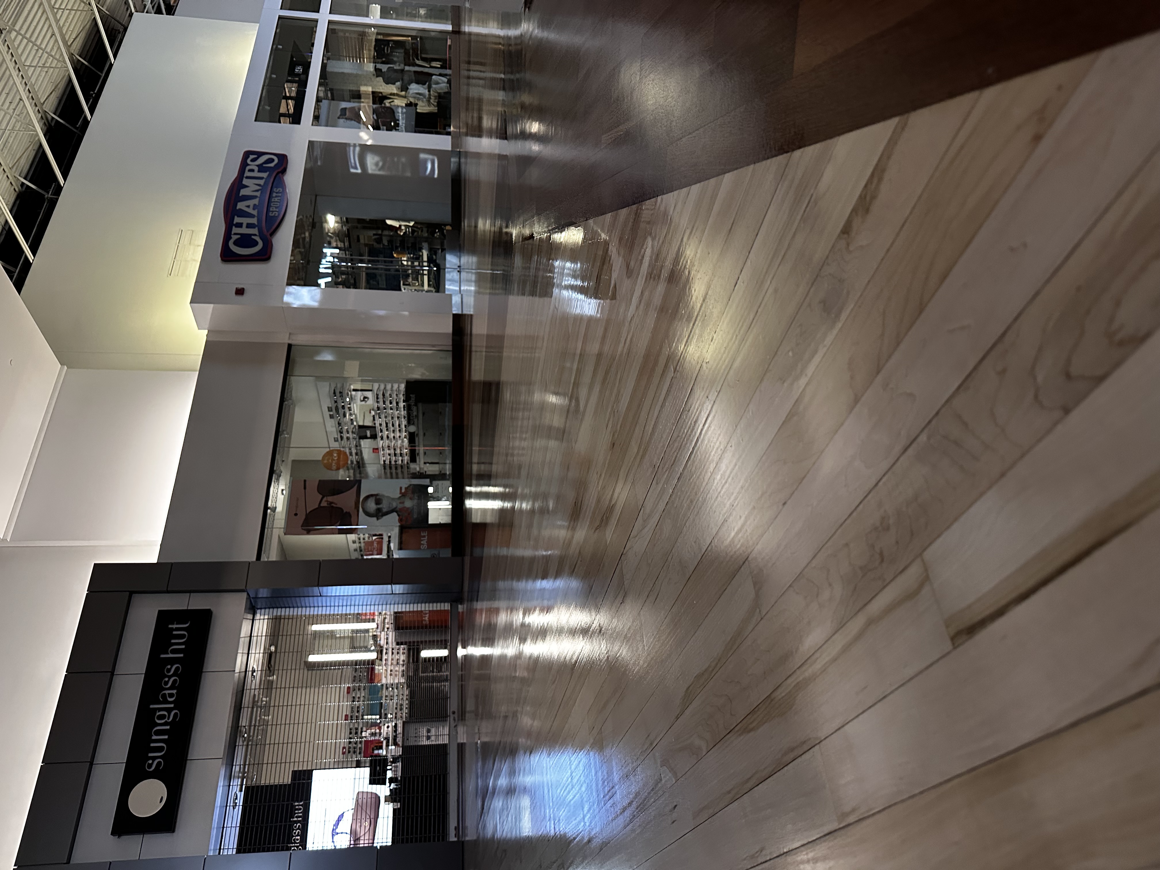 Polished commercial wood flooring in a shopping center concourse