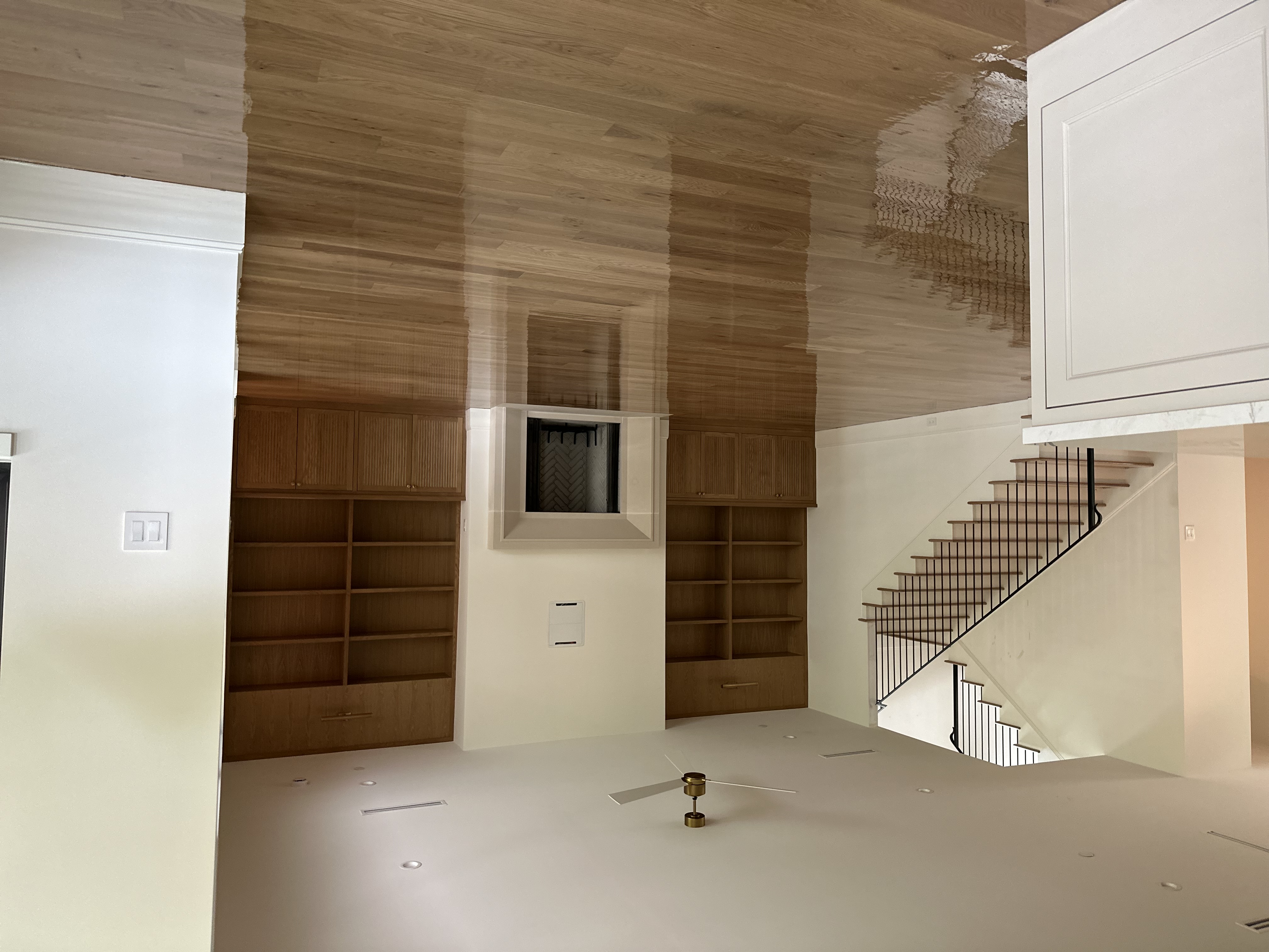 Timeless Wood Flooring great room with glossy oak floors and built-ins