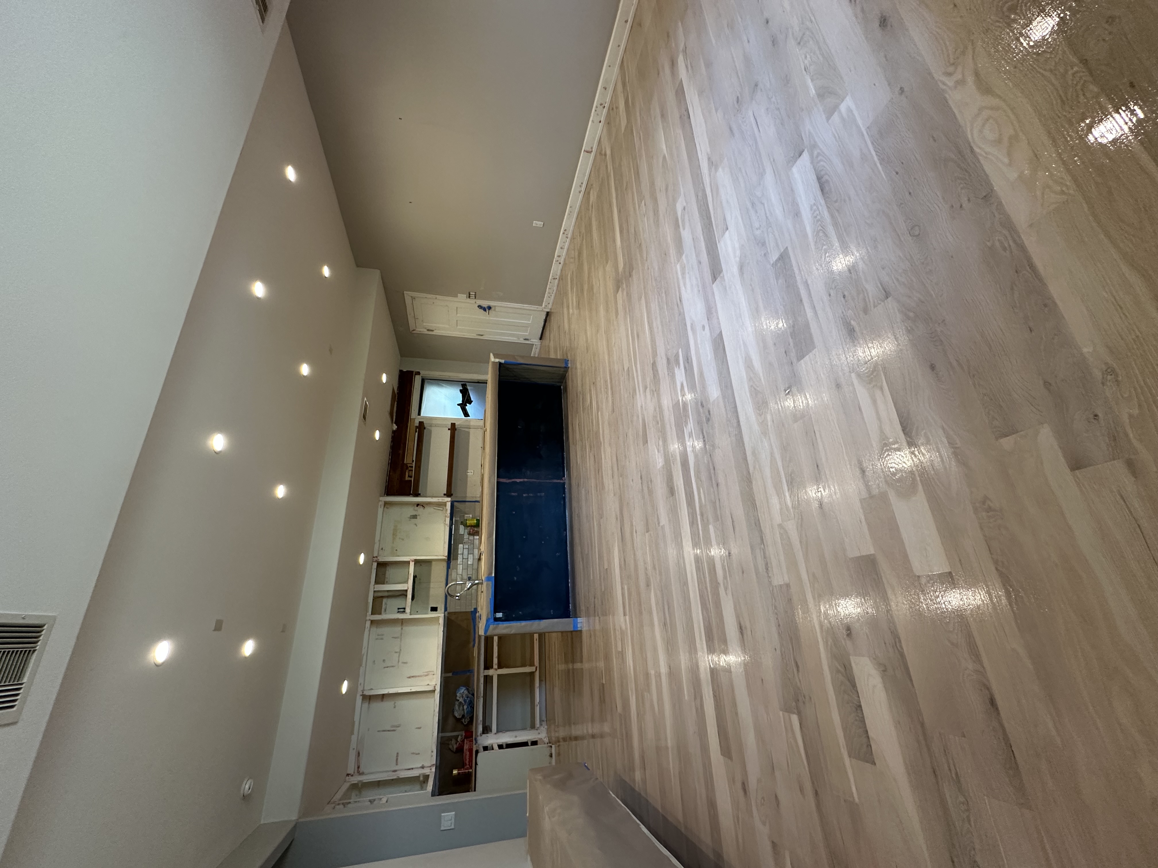 Light natural white oak floors in an open-plan kitchen renovation